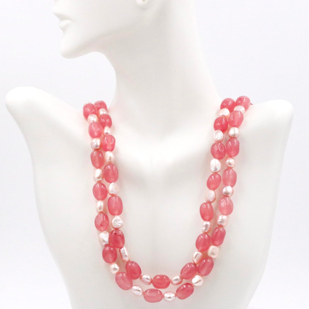 pink pearl necklace on a white dummy