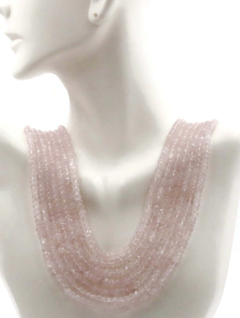 A dummy wearing rose pink layered necklace